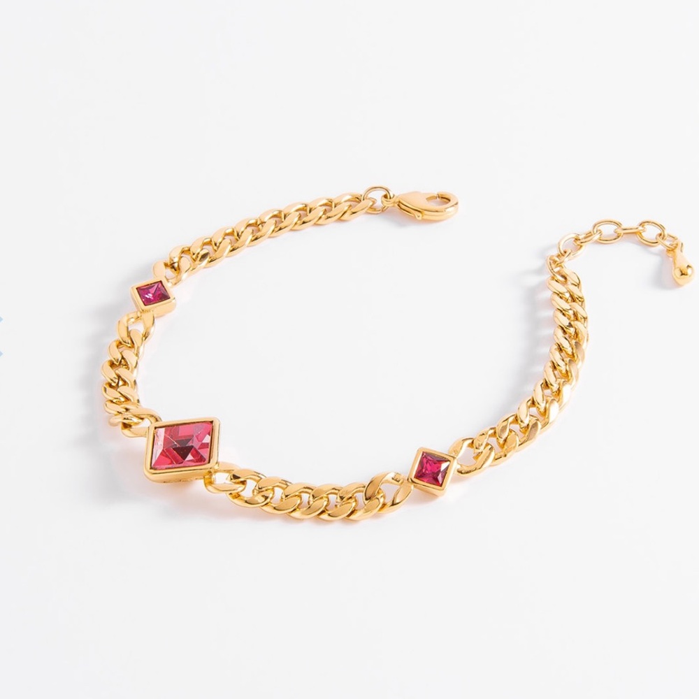 Gold-Plated chain bracelet with fuchsia-toned stone.